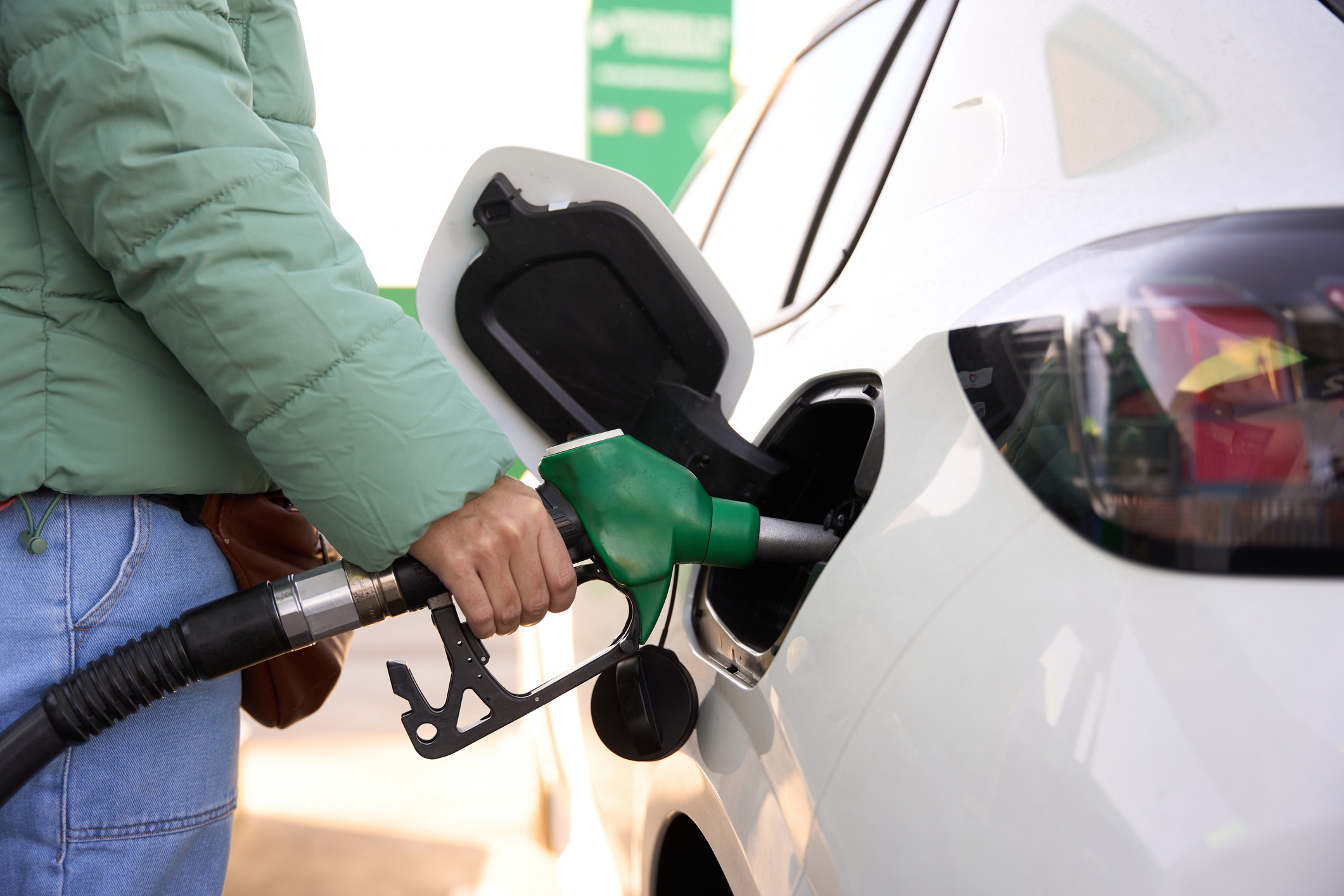 Close-up of a woman filling up her car with petrol
