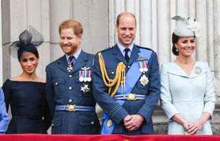Meghan, Duchess of Sussex, Prince Harry, Duke of Sussex, Prince William, Duke of Cambridge and Catherine, Duchess of Cambridge stand on the balcony of Buckingham Palace to view a flypast to mark the centenary of the Royal Air Force