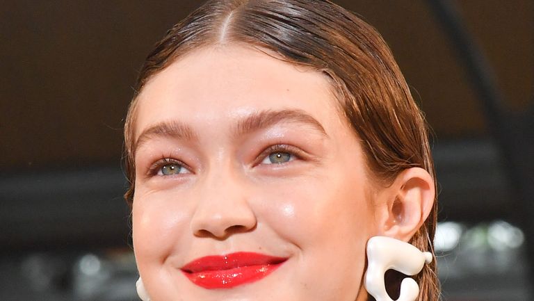 paris, france june 20 gigi hadid wears a brown cap, earrings, a white shirt outside vuitton, during paris fashion week menswear springsummer 2020, on june 20, 2019 in paris, france photo by edward berthelotgetty images