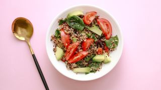 Quinoa salad on pink background