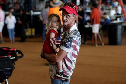 Steve Durand, and his daughter, attend a campaign rally for Donald Trump in Ocala, Florida, October 2016.
