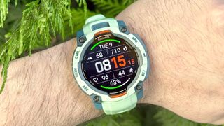 Garmin Instinct 3 close-up in teal on a user's wrist