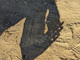 the shadow of a partially-blocked sun can be seen in the shadow of a person's hands
