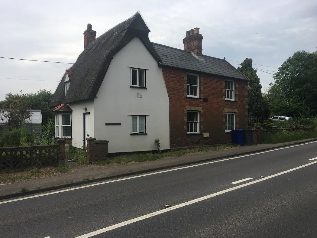 The exterior of Ivy Cottage beside a road
