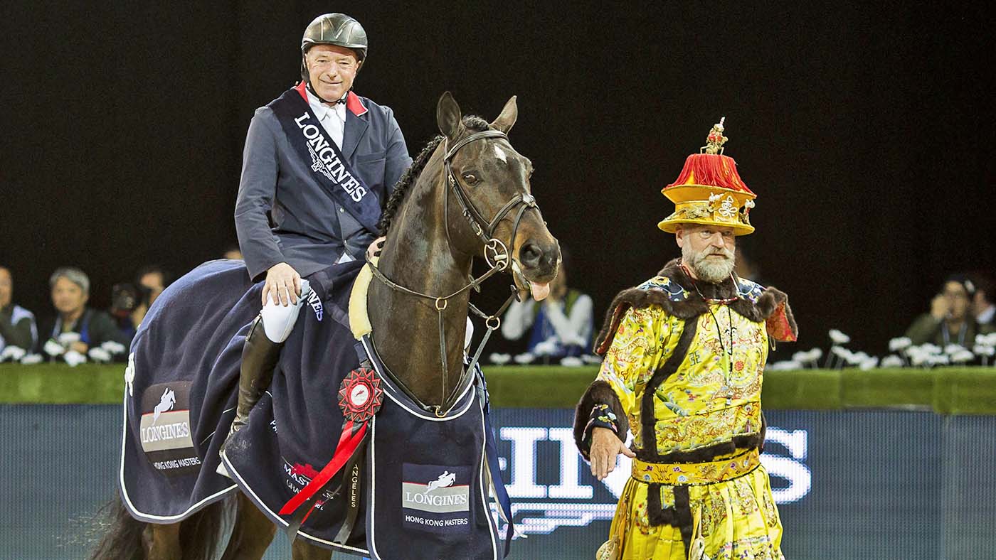 HONG KONG, HONG KONG SAR - FEBRUARY 15: Ringmaster Pedro Cebulka (right) guides John Whitaker of United Kingdom on the course after he won the Longines Grand Prix during the Longines Hong Kong Masters 2015 at the Asiaworld Expo on 15 February 2015 in Hong Kong, China. (Photo by Power Sport Images/Getty Images) Pedro Cebulka, Flamboyant Ringmaster of the Equestrian World