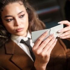 A model backstage at fashion week shows her press-on nails.