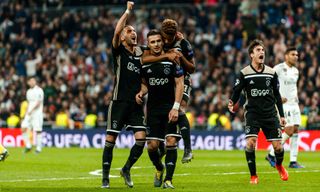 Dusan Tadic of Ajax celebrates his goal with team mates during the UEFA Champions League Round of 16 Second Leg match between Real Madrid and Ajax at Santiago Bernabeu on March 5, 2019 in Madrid, Spain.