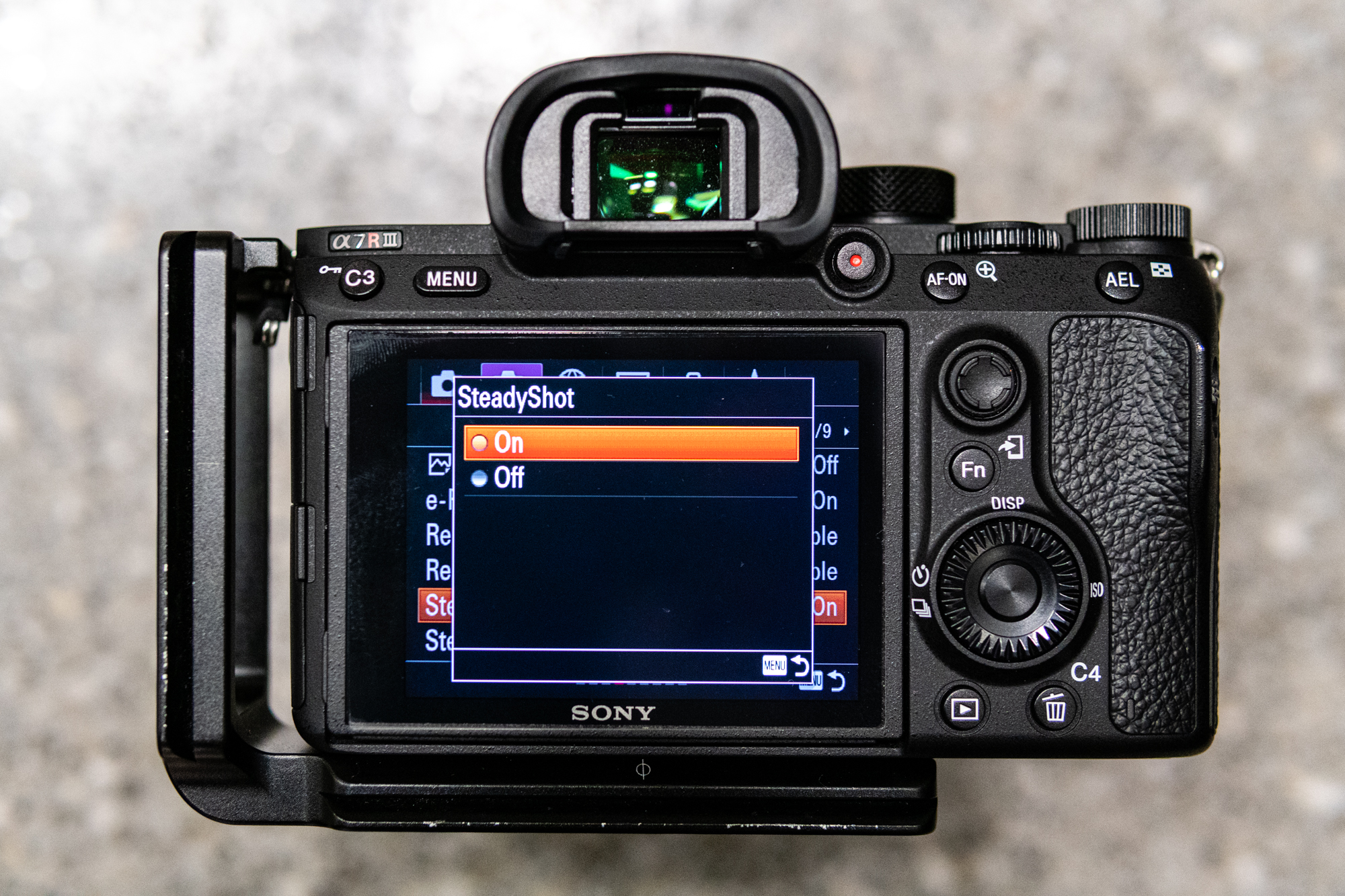 Rear screen of a Sony mirrorless camera with menu showing Steadyshot image stabilization option