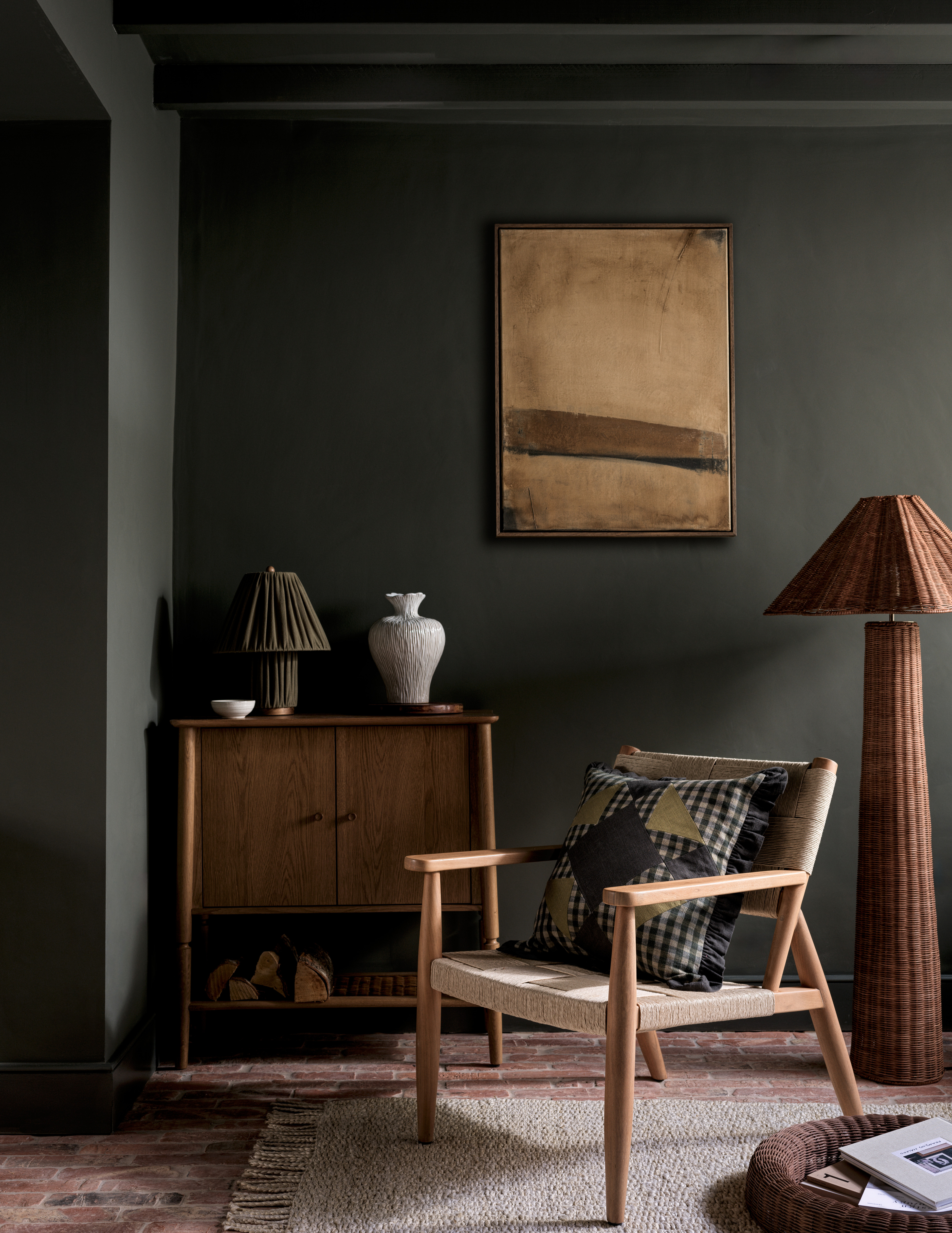 a dark living room with rustic textures, wooden furniture and a beige artwork on the walls
