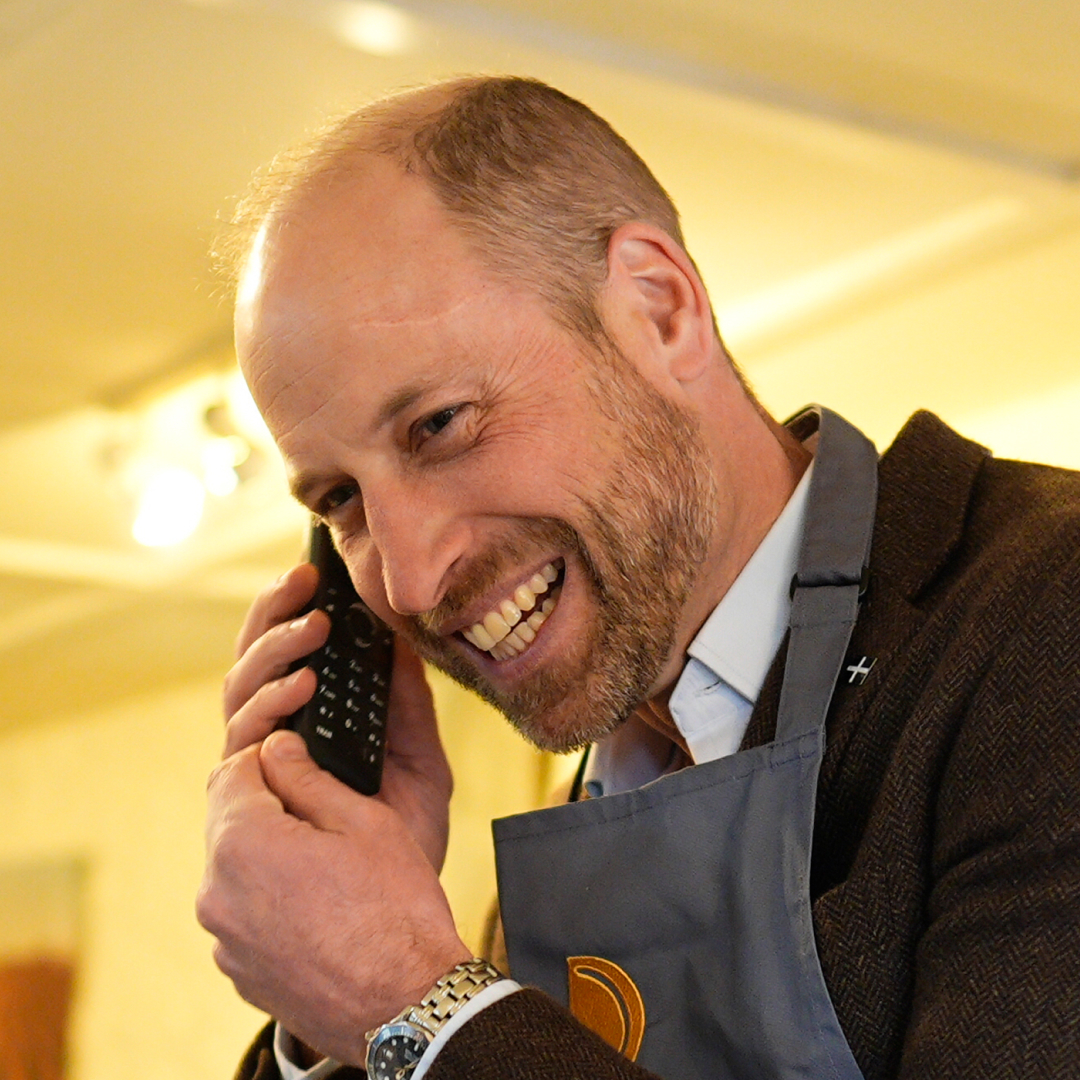 Prince William answering a phone and laughing
