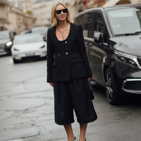 woman wears scoop neck black blazer