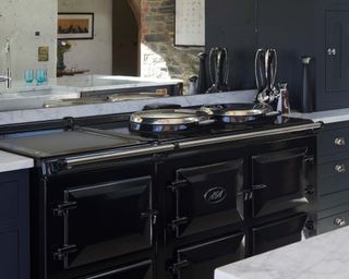 modern kitchen with black aga oven and marble kitchen island