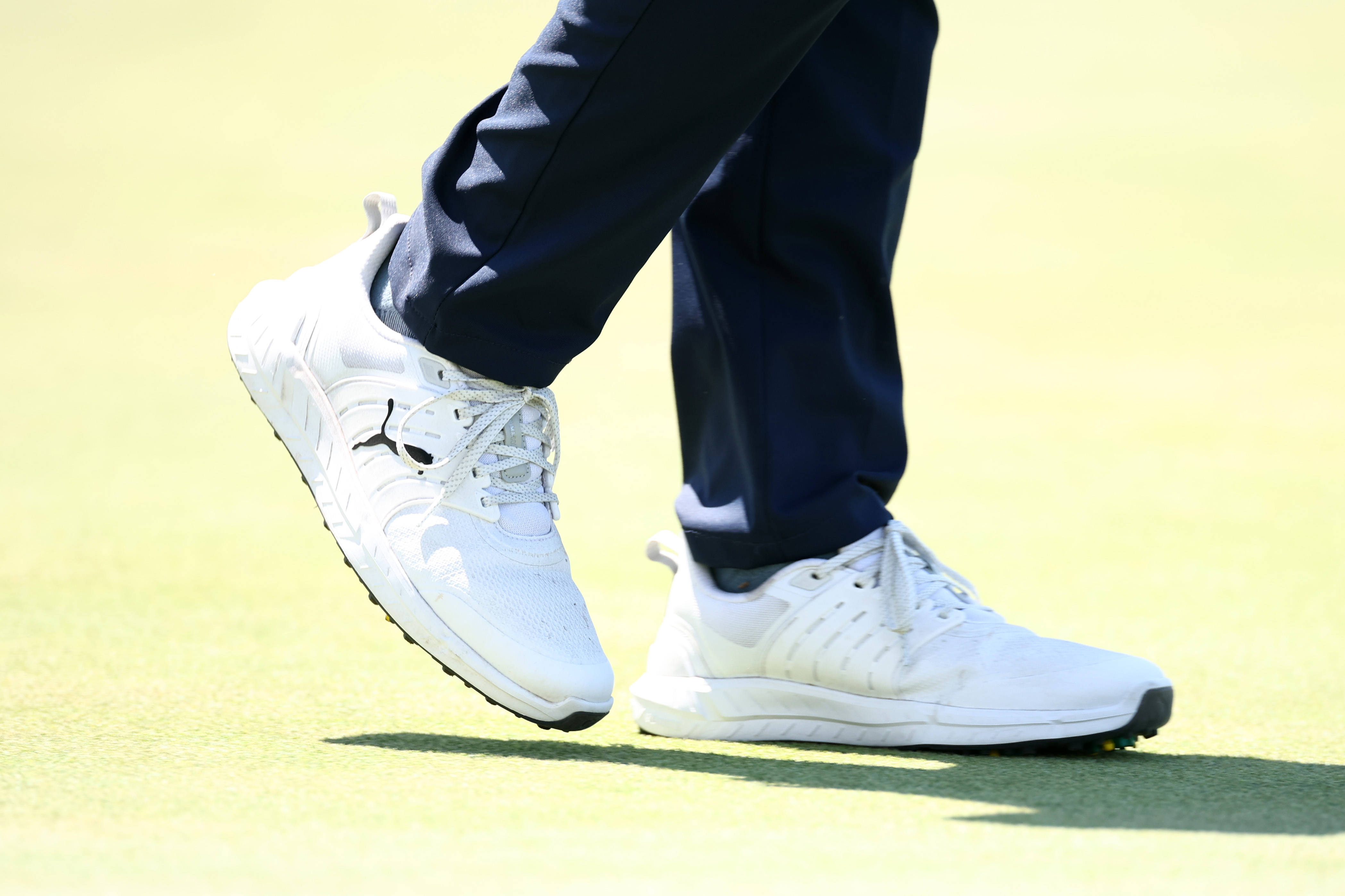 A close up of J.J. Spaun's shoes