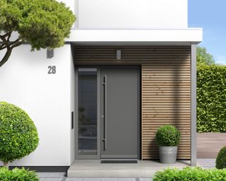 Modern home with charcoal front door and no-grass front yard