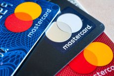 Three Mastercard credit cards fanned out.
