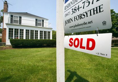  "SOLD" sign is visible below a realtor's "FOR SALE" sign in front of a single-family home July 27, 2004 in Park Ridge, Illinois.