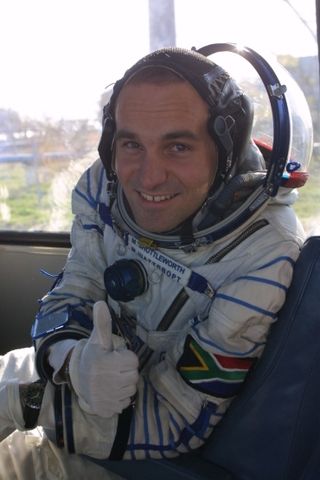 South African businessman Mark Shuttleworth gives a hearty thumbs up sign during preparations for his 2002 trip to the International Space Station, making him the second space tourist.