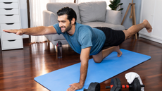 A man performing the core exercise 'bird dog'