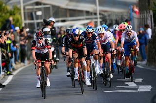 Tadej Pogacar, Wout van Aert, and Mathieu van der Poel lead the peloton during the 2022 Milan-San Remo