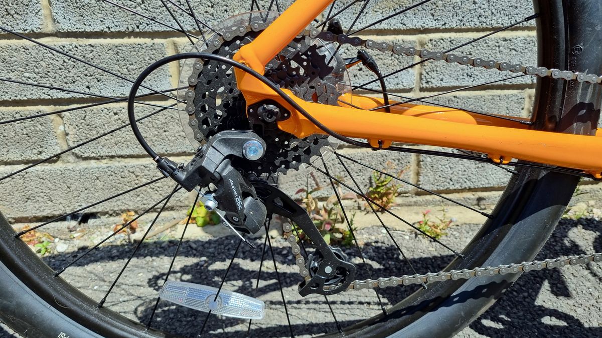 A close up of a cassette and MicroSHIFT rear derailleur