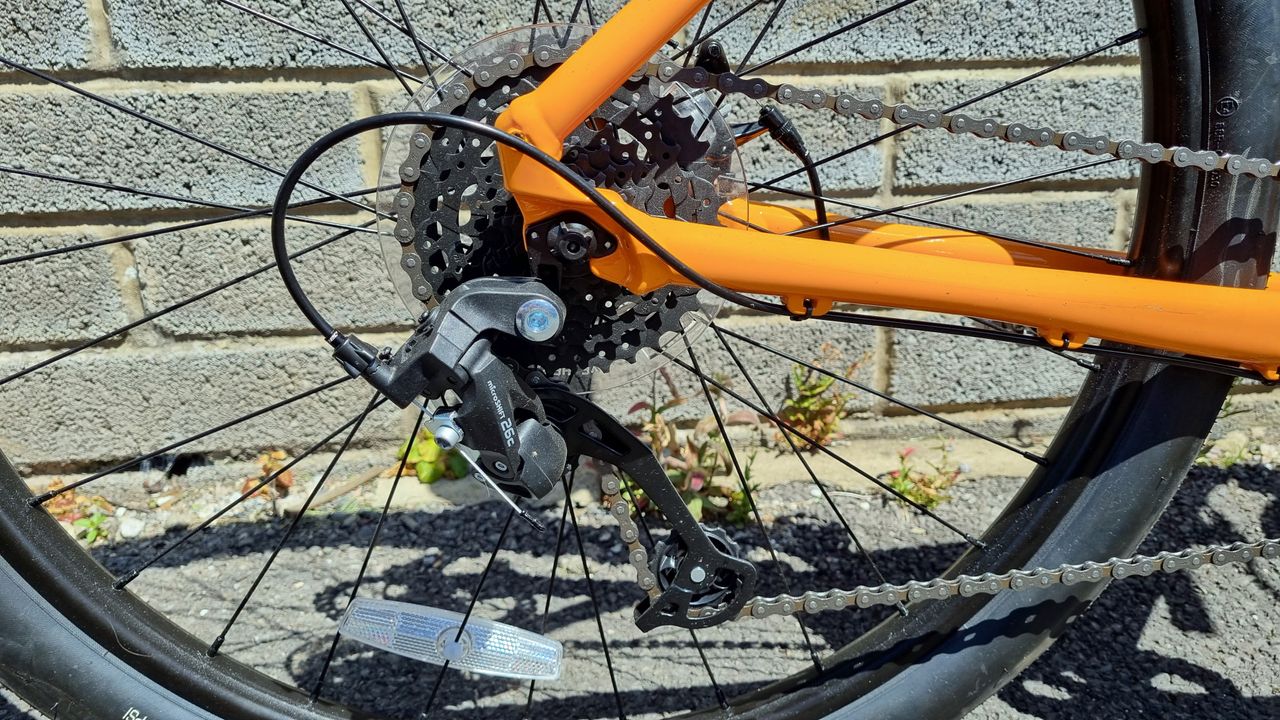 A close up of a cassette and MicroSHIFT rear derailleur