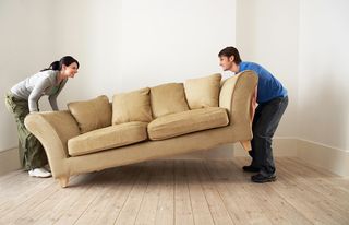 A couple moves a couch
