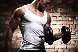 A muscular man lifts weights.