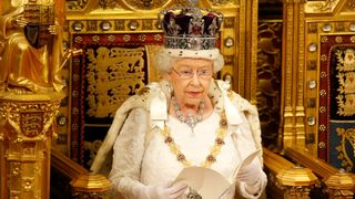 LONDON, ENGLAND - MAY 18: Queen Elizabeth II reads the Queen's Speech from the throne during State Opening of Parliament in the House of Lords at the Palace of Westminster on May 18, 2016 in London, England. The State Opening of Parliament is the formal start of the parliamentary year. This year's Queen's Speech, setting out the government's agenda for the coming session, is expected to outline policy on prison reform, tuition fee rises and reveal the potential site of a UK spaceport.