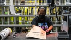 A worker preparing packages at an Amazon warehouse in the Bronx, New York City