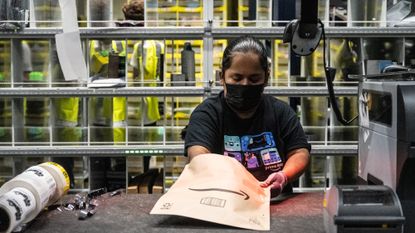 A worker preparing packages at an Amazon warehouse in the Bronx, New York City