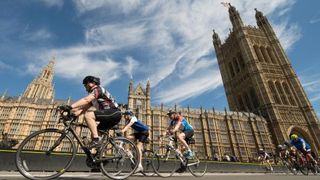 Cyclists taking part in RideLondon passing the Houses of Parliament