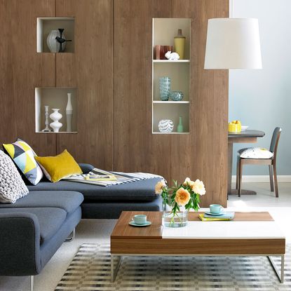 wooden wall with flower vase on wooden table 