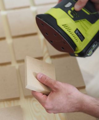 sanding the side of some wooden blocks