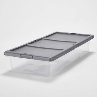 A clear under bed storage box with a gray lid