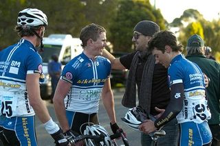 Bikebug.com team manager and former pro-rider Trent Wilson congratulates Philip Grenfell on his stage win.