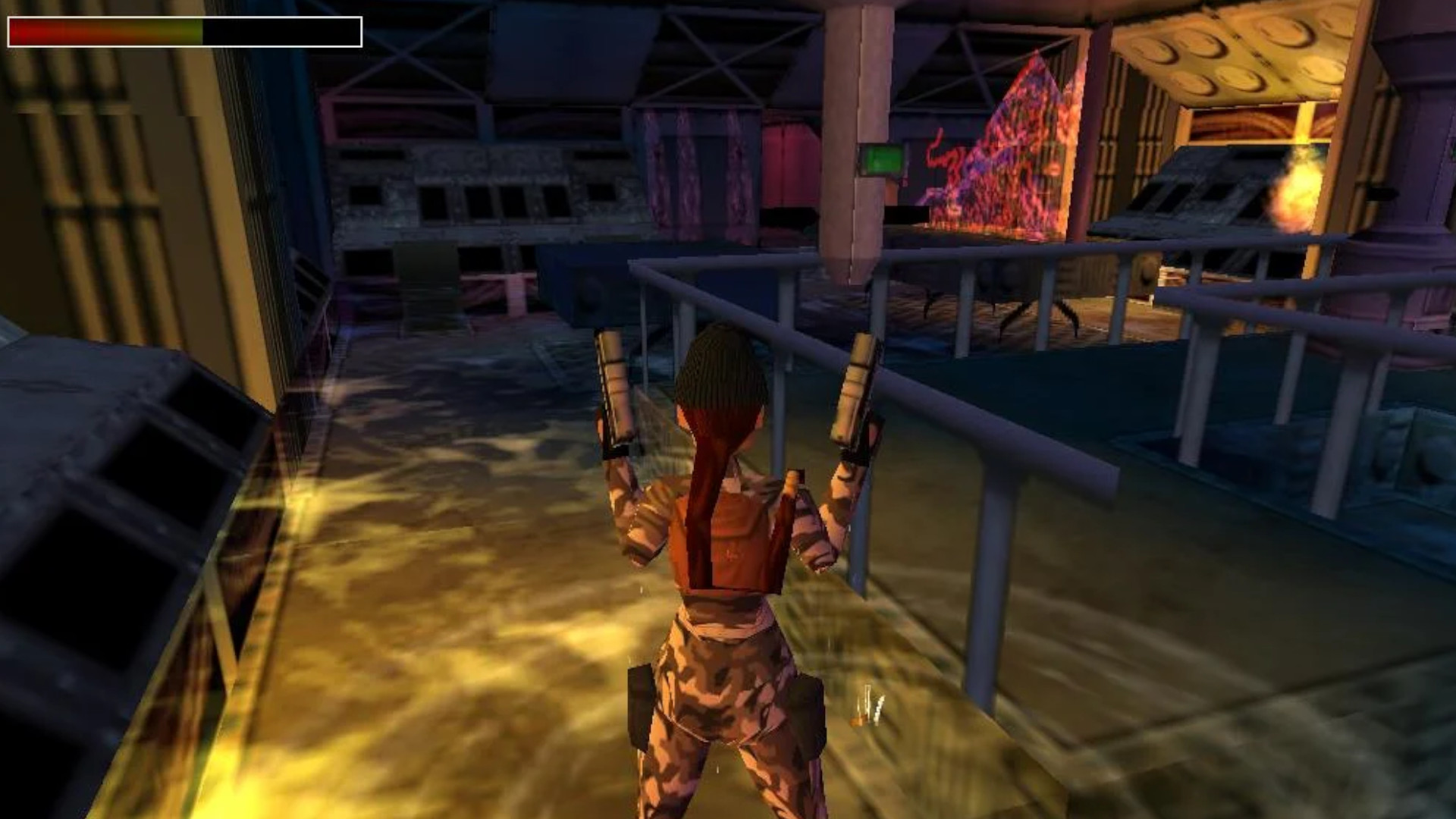 Lara Croft dressed in camo and holding two guns at night with her health bar displayed in the top left, showing a gameplay section from one of the best Tomb Raider games, Tomb Raider: Chronicles.