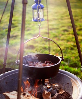 cooking pot hanging over fire pit