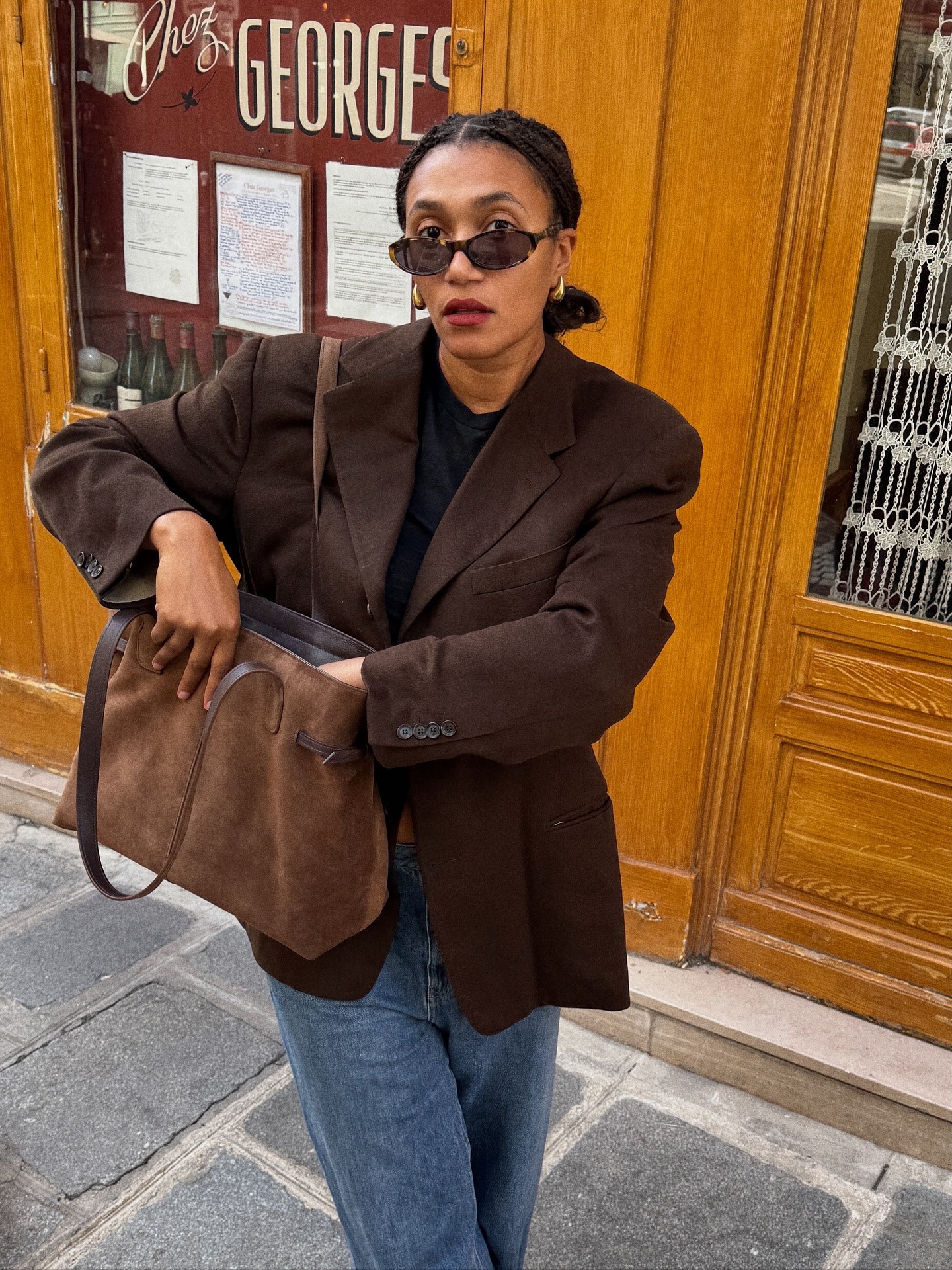 Woman wearing oversize blazer in street style shot.