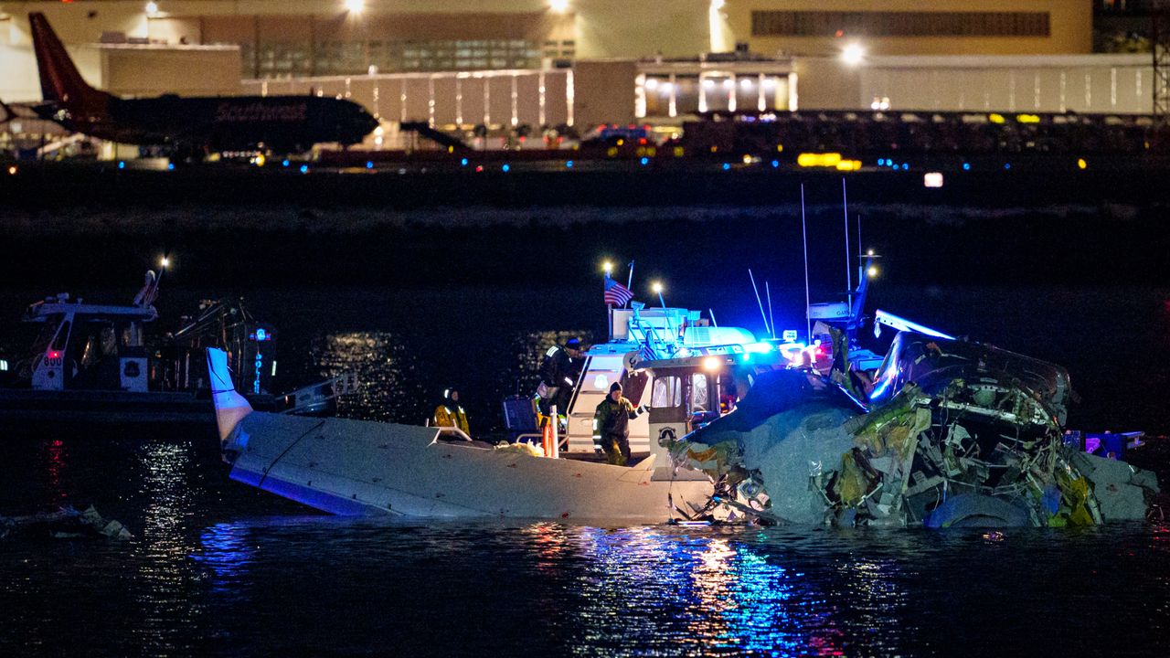 Search crews examine wreckage on the Potomac River after midair passenger jet-Blackhawk helicopter collision