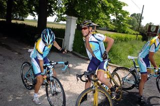 Lance Armstrong (Astana) getting his radio situated on the side of the road.