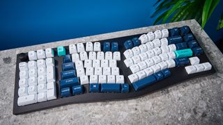 A black Keychron Q14 Max Alice keyboard with white, blue and teal keycaps