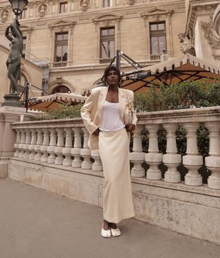 @lefevrediary wearing a cream jacket-and-skirt set with a white tank top and white shoes.