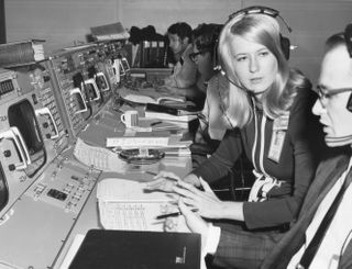 Frances "Poppy" Northcutt (center) speaks with a colleague during Apollo 8 in December 1968 at NASA's Mission Control at the Johnson Space Center in Houston. Northcutt was the first female engineer in Mission Control, working in one of the complex's back rooms.