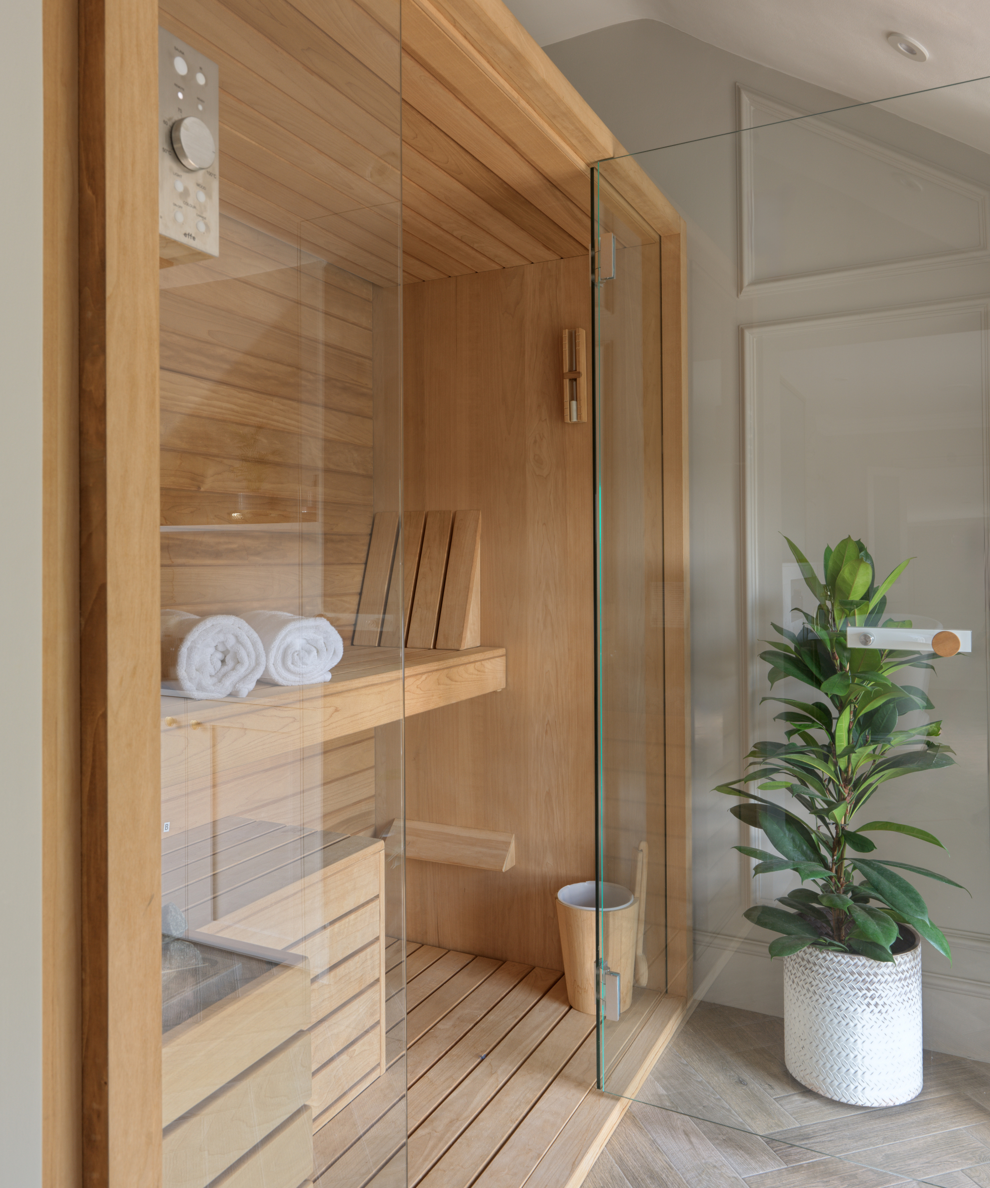 wooden and glass fronted sauna in bathroom