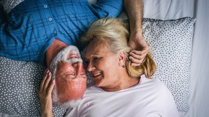 older couple in bed together in bed