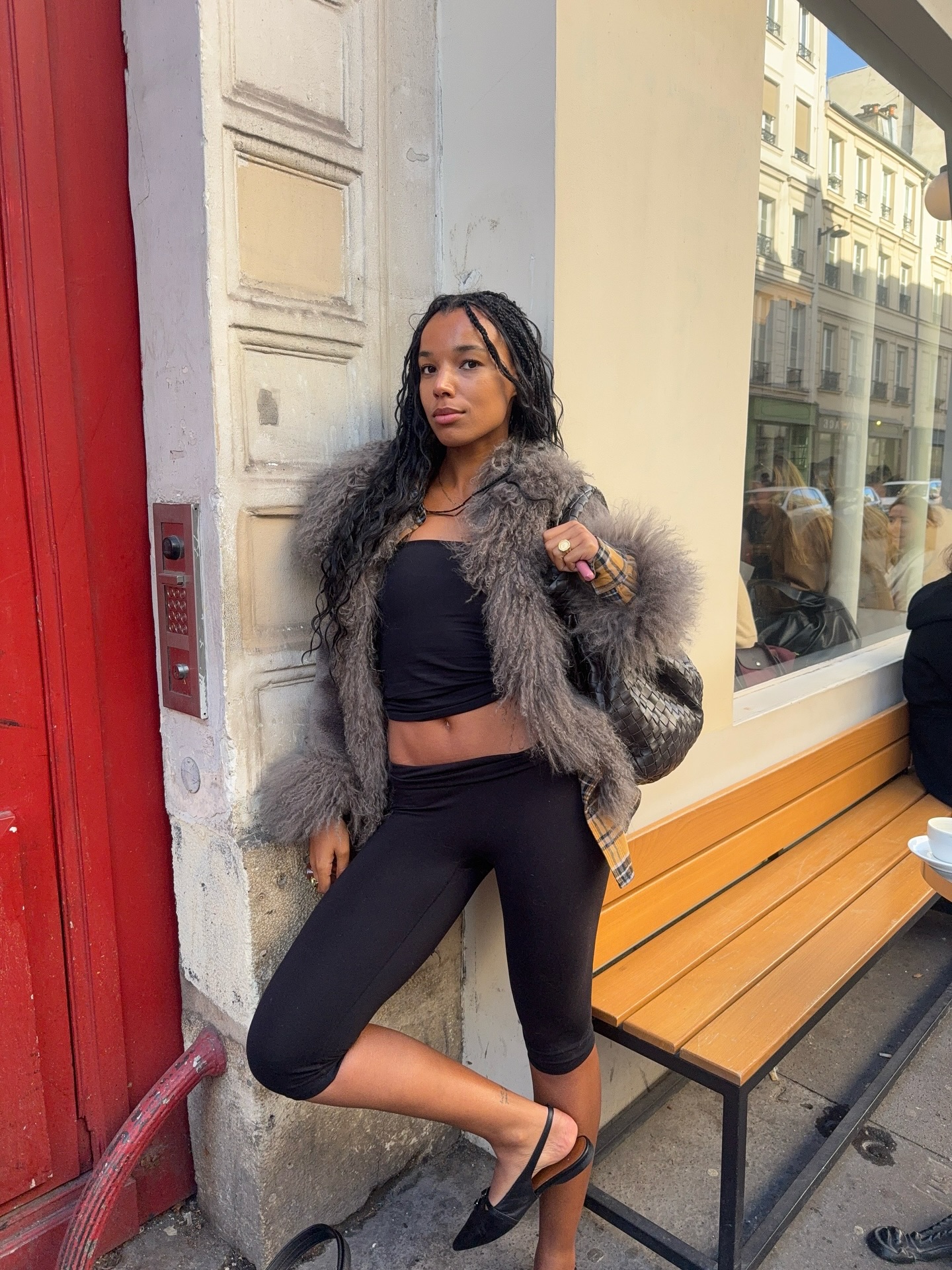 An image of @fiahamelijnck wearing capri leggings with sling backs and a faux fur jacket, one of the biggest trends to wear with leggings in 2026.