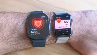 A user's wrist showing the heart rate reading from an Apple Watch Ultra 2 (69 bpm) and Armitron Matrix smartwatch (66 bpm)