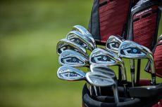 A selection of Wilson golf clubs in a golf club bag.