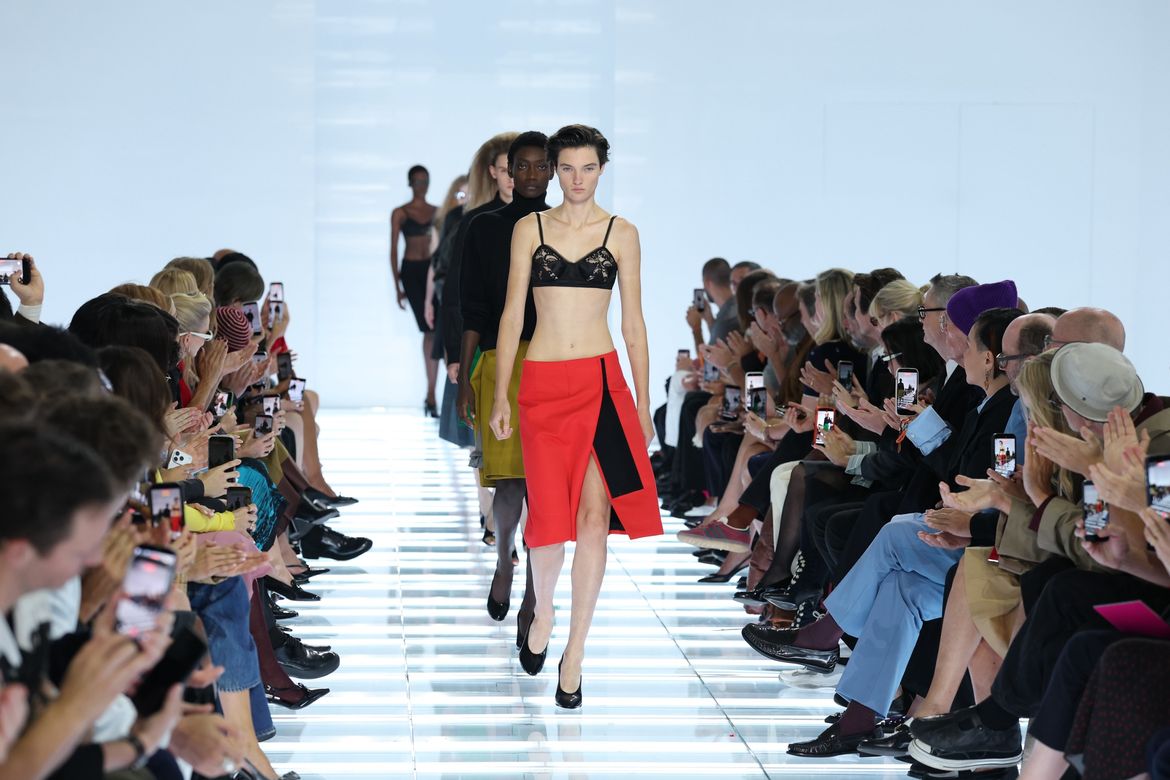 Model on the runway in a red skirt