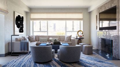 neutral living room with blue accents and patterned rug